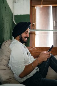 Indian man playing on mobile phone